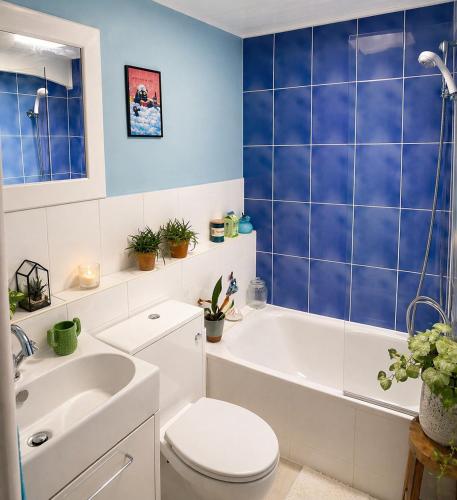 a bathroom with a tub and a toilet and a sink at Greytree Cottage in Ross on Wye