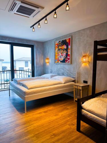 a bedroom with a bed and a painting on the wall at Vila CampoAmor Pasohlávky in Pasohlávky