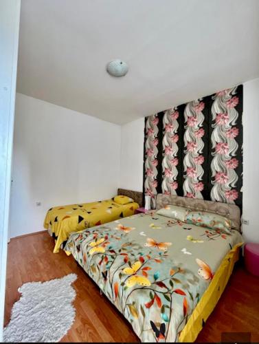 a bedroom with a bed with a yellow comforter at Centar S in Pirot