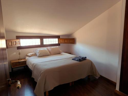 a bedroom with a large bed with a window at Apartamentos Casa Memé in Mora de Rubielos