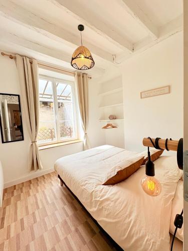 a bedroom with a bed and a window at Le Boudoir in Amboise