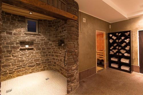a room with a brick wall and a wine cellar at Hotel Bärenbachhof in Saalbach-Hinterglemm