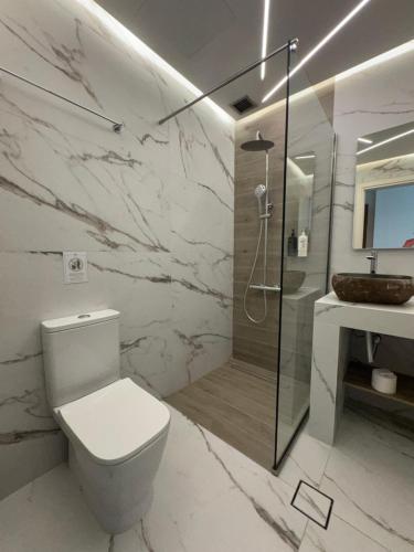 a bathroom with a toilet and a shower and a sink at My Way Hotel & Events in Patra