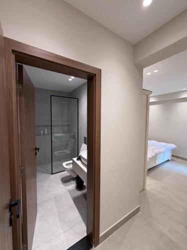 a bedroom with a bed and a bathroom with a sink at Chic Stays Modern 3BR in Mountain View ICITY in 6th Of October