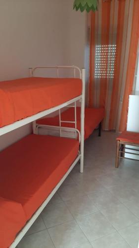 a bedroom with two bunk beds in a room at Casa GIGIA in Sperlonga