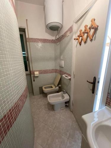 a bathroom with a toilet and a sink at Casa GIGIA in Sperlonga