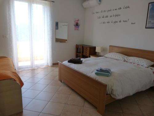 a bedroom with a bed with towels on it at La Testa Fra Le Nuvole in Finale Ligure