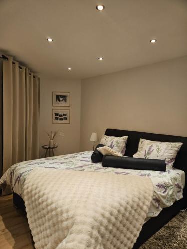 a bedroom with a large bed in a room at Die Haas-Villa in Berg