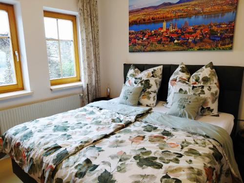 a bedroom with a bed and a painting on the wall at Mein Wein Apartment in Krems an der Donau