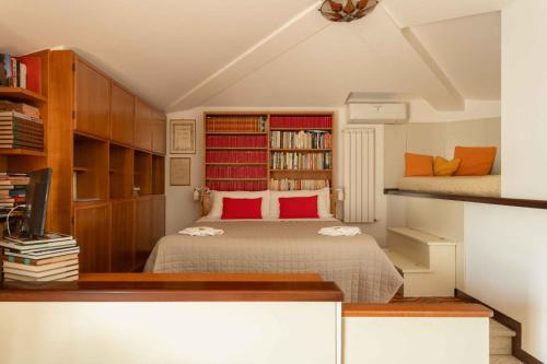 a bedroom with a bed with red pillows at sopra al FORTE in Querceta
