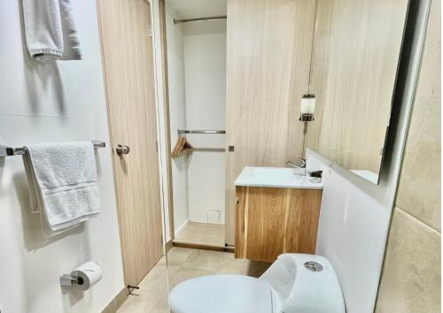 a bathroom with a white toilet and a sink at Reset (Hotel-Cafe-Coworking) in Cali