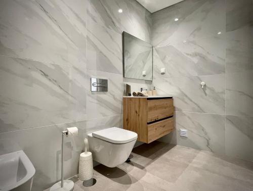 a bathroom with a toilet and a sink at Apt IM - With pool, wifi and parking in Pêra