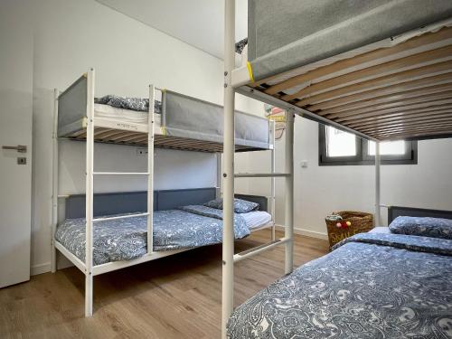 a bedroom with two bunk beds in a room at Apt IM - With pool, wifi and parking in Pêra