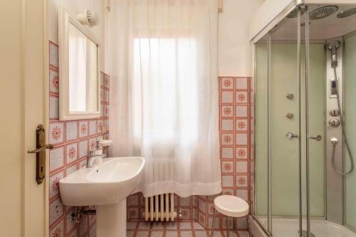 a bathroom with a sink and a shower at sopra al FORTE in Querceta