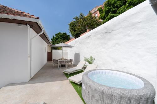 a patio with a pool and chairs and a table at HostWise - Traditional House with Terrace in Porto