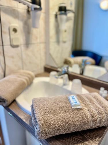 a bathroom with a sink and a towel on a counter at Hotel Antoni in Bochum