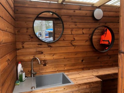 a bathroom with a sink and a mirror at Saare-Toominga camping house in Väike-Rakke