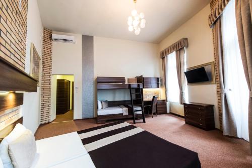 a hotel room with a bed and a television at SOUS44 in Budapest