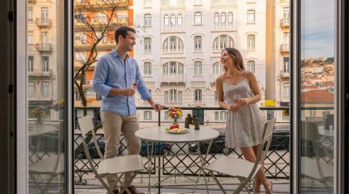 a man and a woman standing on a balcony at LX51 Lisbon Center - Studios & Suites by APT IIN in Lisbon