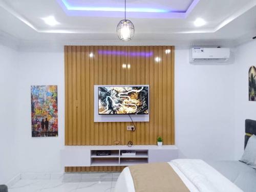a bedroom with a bed and a painting on a wall at PrimeAxishub in Ilorin
