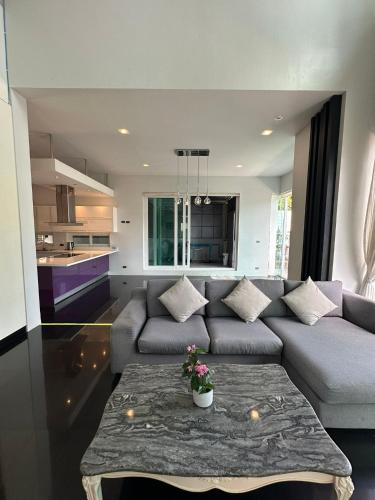 a living room with a couch and a table at Villa Worawan Pool Villa Bo Phut in Nathon Bay