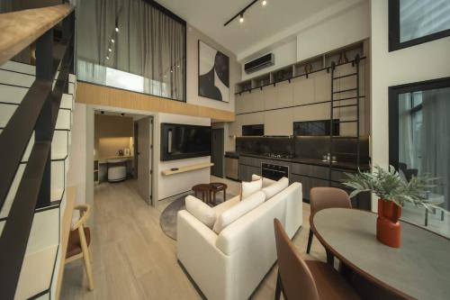 a living room with a white couch and a table at Luxury 2br Apt & Pool access in Panama City