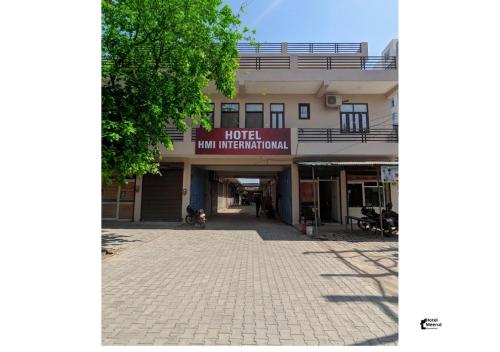a building with a sign that reads hotel main line information at Hotel HMI International in Meerut