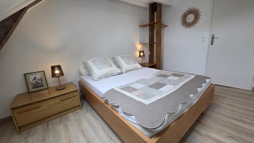 a bedroom with a bed and a dresser with a mirror at Gîte du moulin d'Arudy en Vallée d'Ossau in Arudy