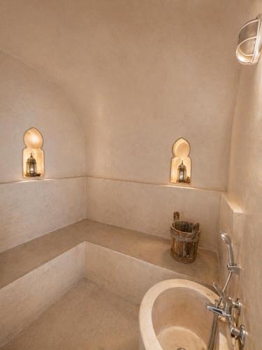 a bathroom with a tub and a sink at Riad Aura Suites & Spa in Marrakesh