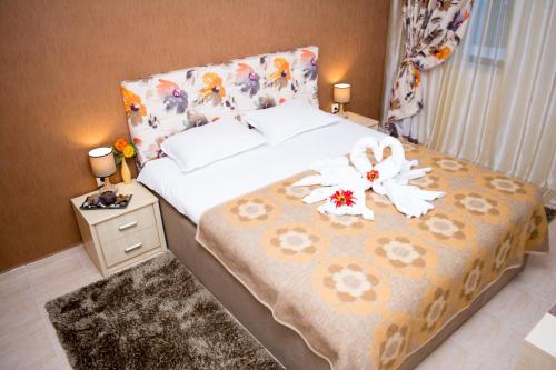 パンポロボにあるDeluxe Apartment Monastery 3のベッドルーム1室(花の飾られたベッド1台付)