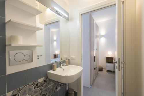 a bathroom with a sink and a mirror at Montebello Room's in Marettimo
