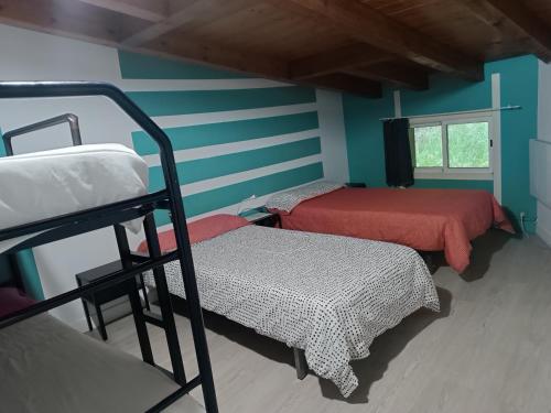 a room with two bunk beds and a window at Albergue Casa Txakainlo in Lesaka