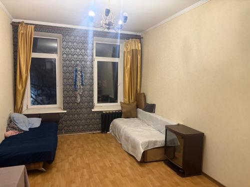 a living room with a couch and a tv at На Еврейской in Odesa