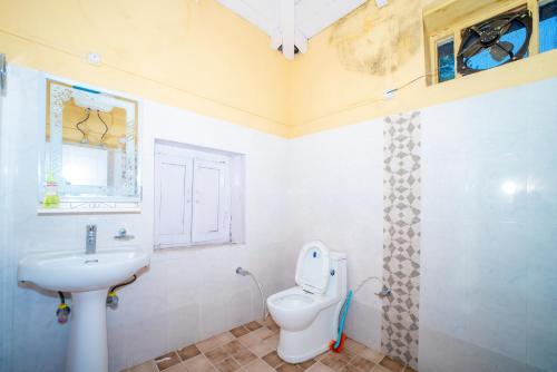 a bathroom with a toilet and a sink at Forest Rest House Gahan in Bāgi