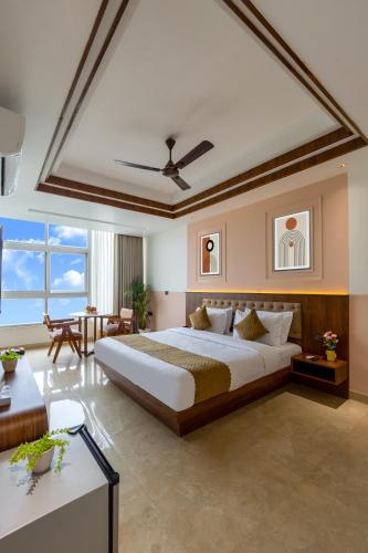 a bedroom with a large bed and a living room at yashobhoomi Hostel in New Delhi