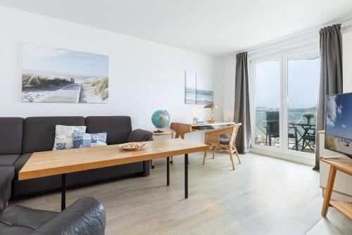 a living room with a couch and a table at Strandhotel Laboe Nr 35 in Laboe