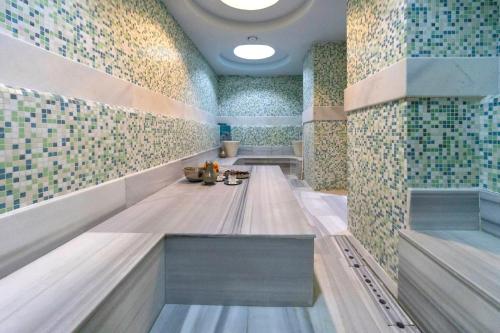 a bathroom with a bench in a room with tiles at Miapera Hotel & Spa - Special Class in Istanbul
