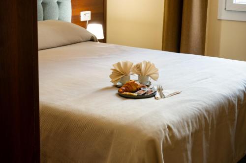 a plate of food on top of a bed at Hotel Genova Liberty in Genoa
