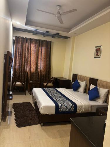 a bedroom with a bed and a window at VR Residency 83 in Gurgaon