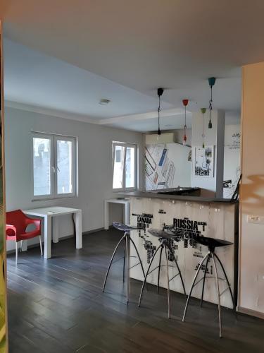 a room with a kitchen with a table and chairs at The High Hostel in Budva