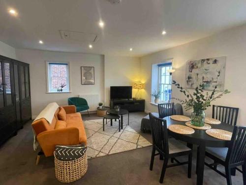 a living room with a couch and a table at Large town centre apartment with parking in Wallingford