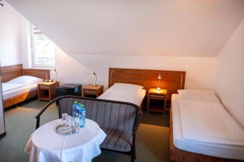 a hotel room with two beds and a table at Pelikan in Aleksandrów Łódzki