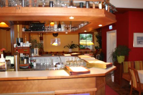 eine Bar in einem Restaurant mit Gläsern auf der Theke in der Unterkunft Jasmin in Schladming