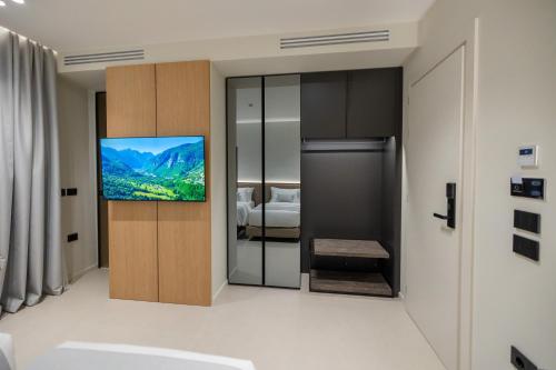 a living room with a tv on a wall at Padma Hotel in Vlorë