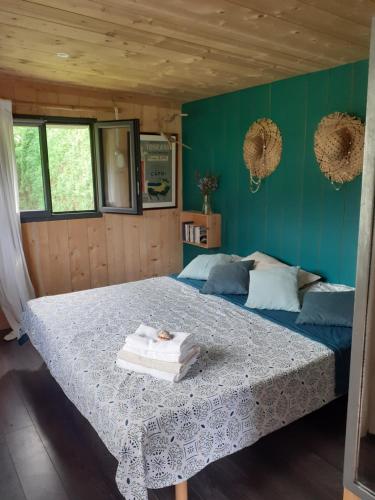 a bedroom with a large bed with blue walls at Maison Hamak in Urrugne