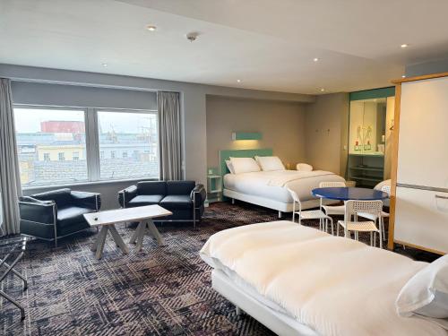 a hotel room with two beds and a window at Citrus Hotel Cheltenham by Compass Hospitality in Cheltenham