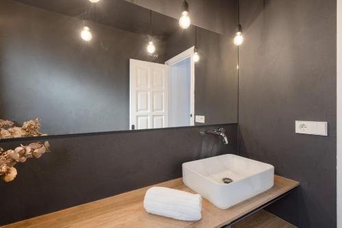 a bathroom with a sink and a mirror at Racó 24 in Pals