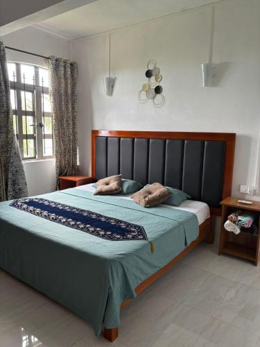 a bedroom with a bed with two pillows on it at Skipper Dan Bungalow in La Gaulette