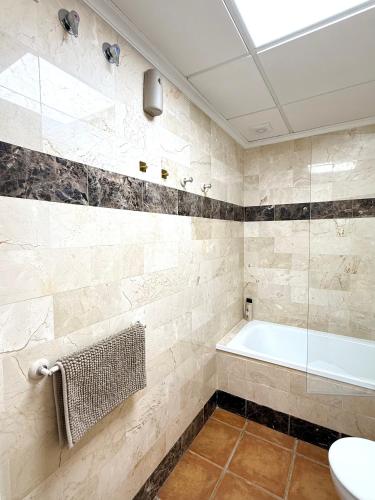 a bathroom with a bath tub and a sink at Heavenly Homes Mojacar 75 in Mojácar
