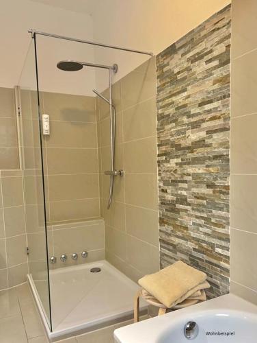 a bathroom with a shower and a tub and a sink at Forsthaus Seebergen in Lütjensee